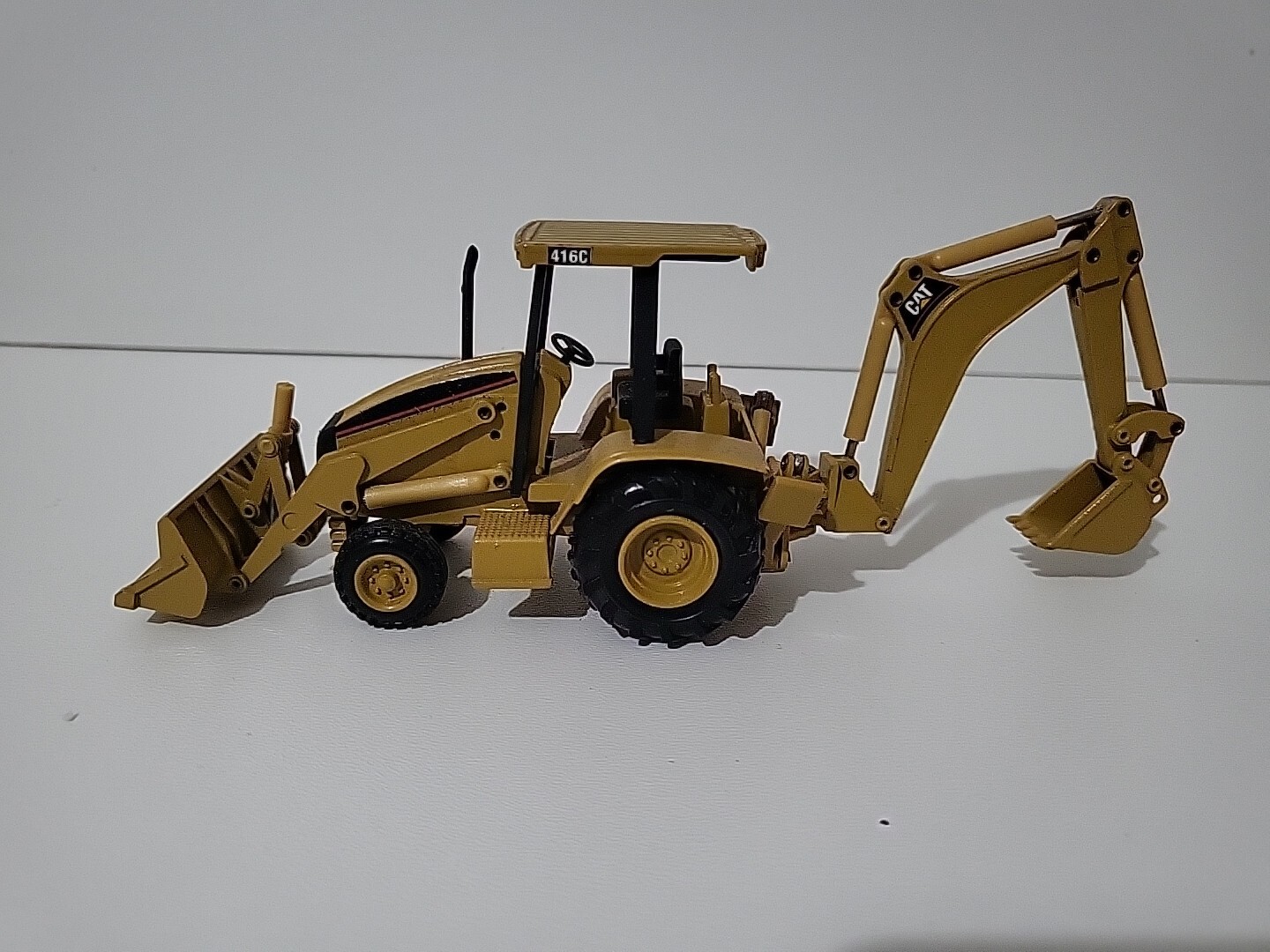 CATERPILLAR 416C Hull Truck with 1/50 Scale Canopy NZG