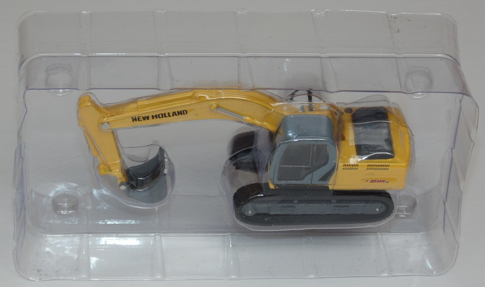 NEW HOLLAND E215B RETROEXCAVA MAQUINARIA PARA CONSTRUCCION 1:87 DIECAST COLOMBIA