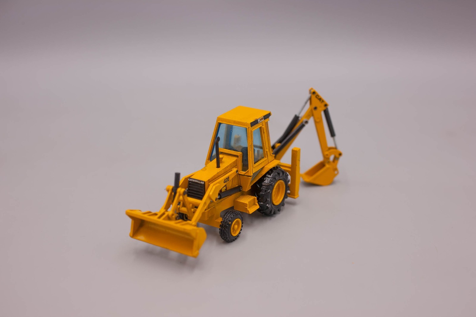 NZG #2851 1:50 Catepillar 428 Backhoe Loader with Sliding Backhoe Arm