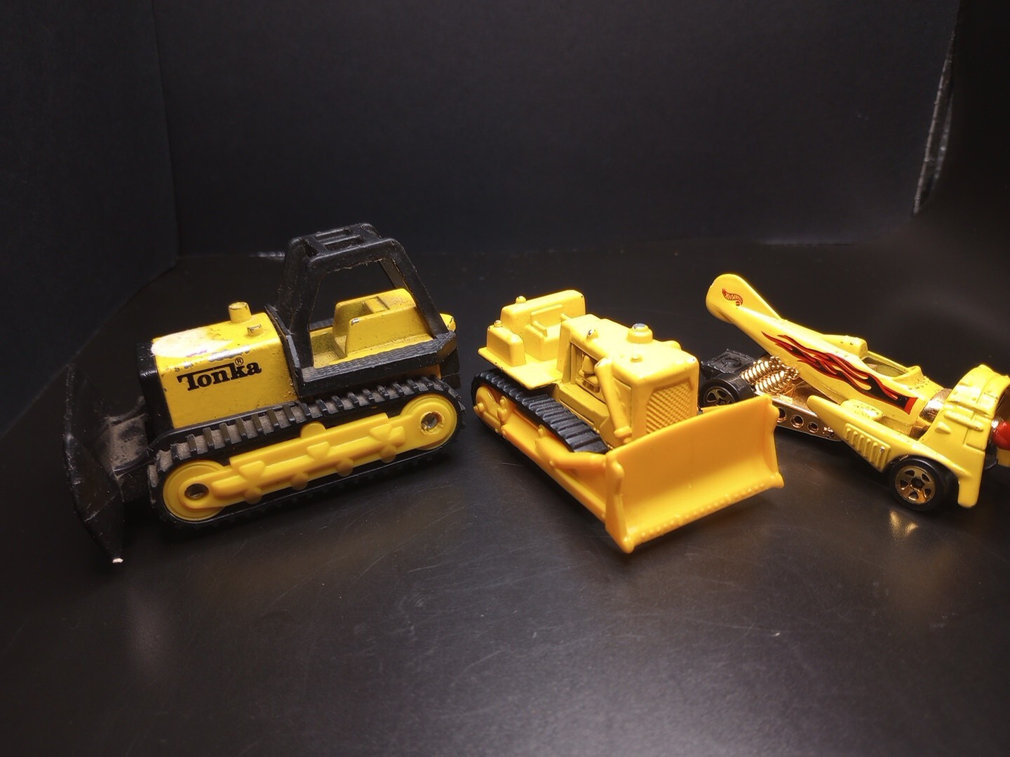 Yellow Die-Cast Tonka Bulldozer + (another) Bulldozer + Hot Wheels Dog Fighter